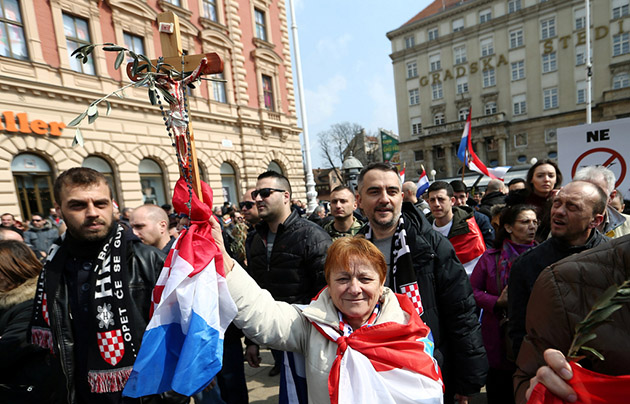 A woman holds a cross during the protest against the ratification of the Istanbul Convention in Zagreb